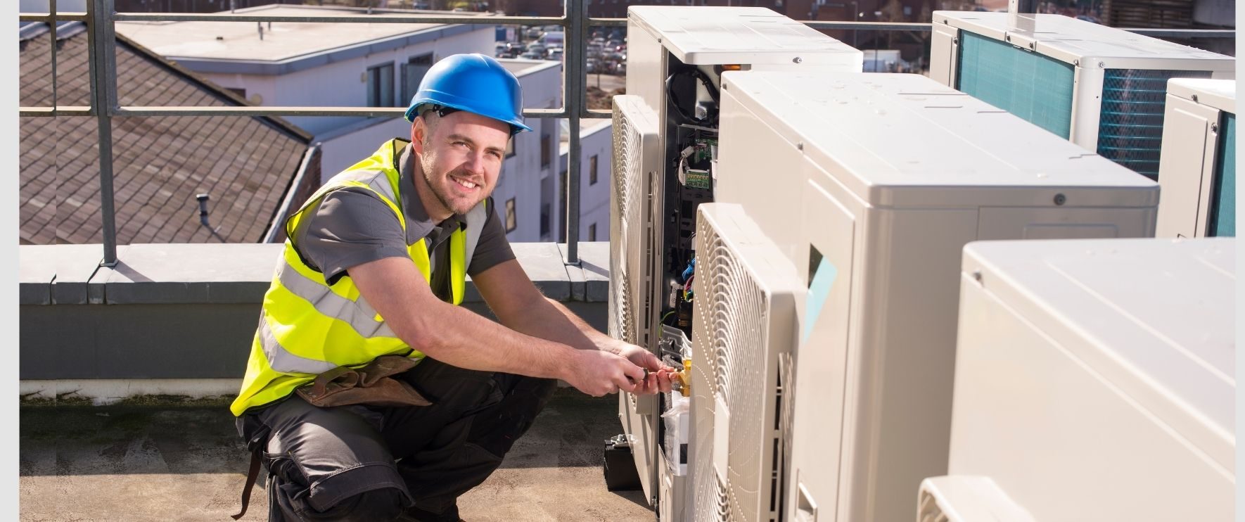 Engineer servicing rooftop air conditioning units