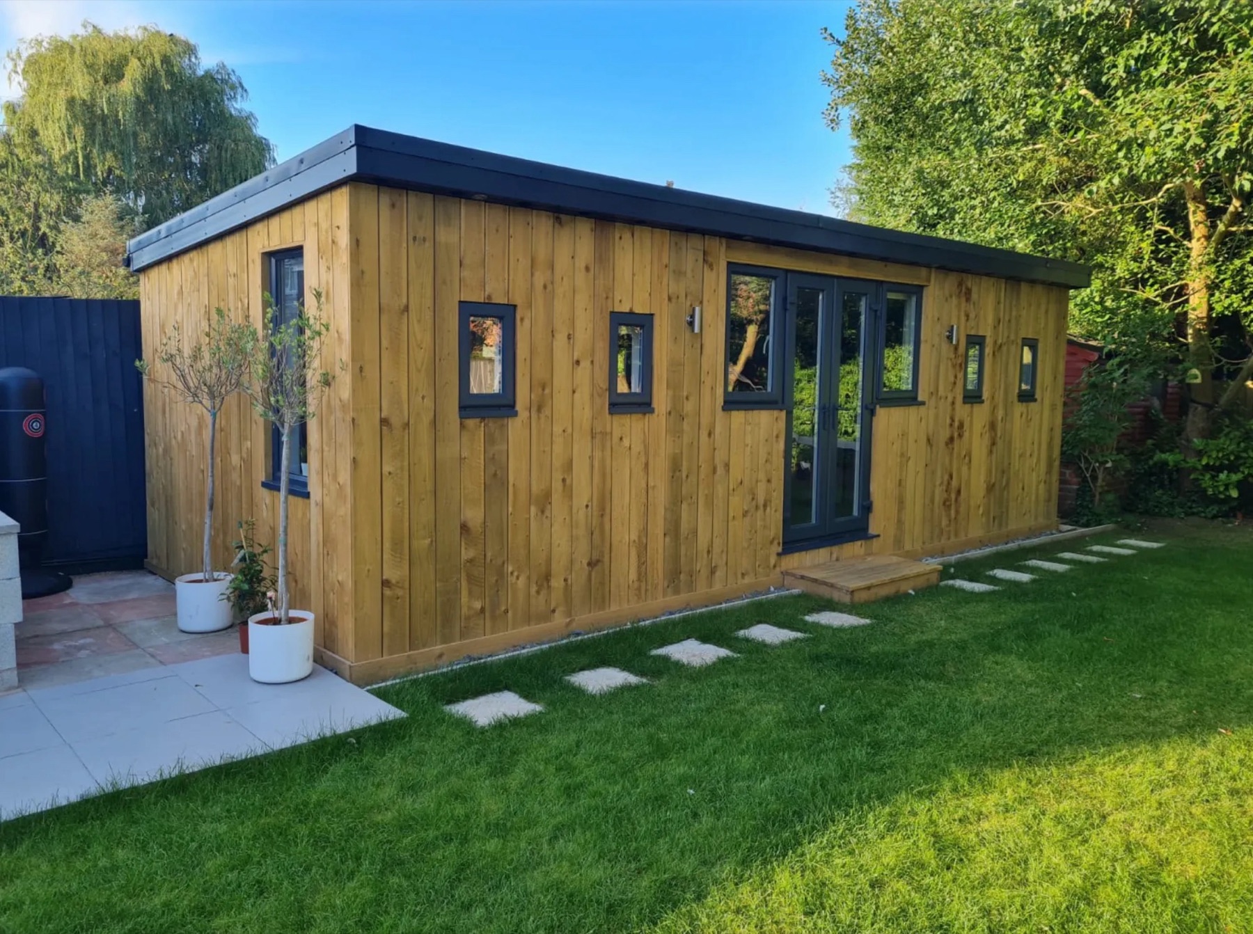 Timber-clad garden room office with the air conditioning installed by Air Distribution